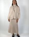 Cardigan van FFC met opgestikte zakken en lange mouwen. De kleur is lichtbeige.