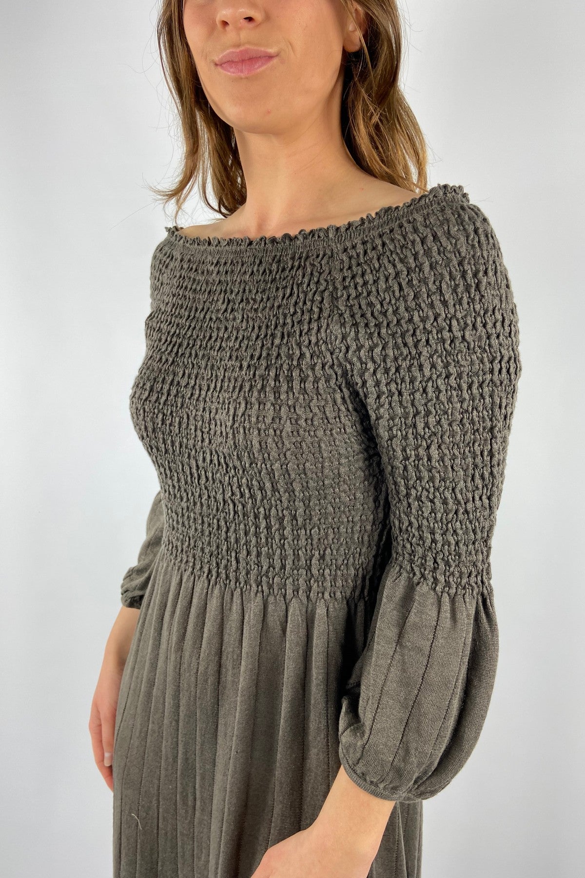 261X827-12: Detail van de ribgebreide structuur en de poffende mouwen van de bruine Hemisphere jurk.