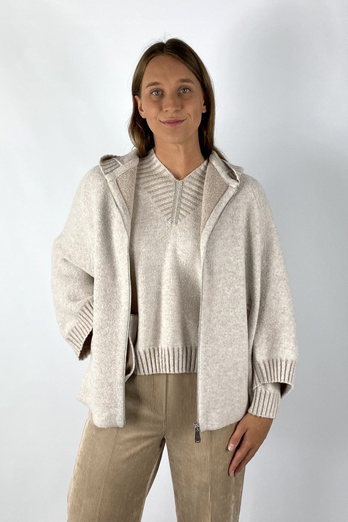 Capemantel met rits in een beige bouclé stof.