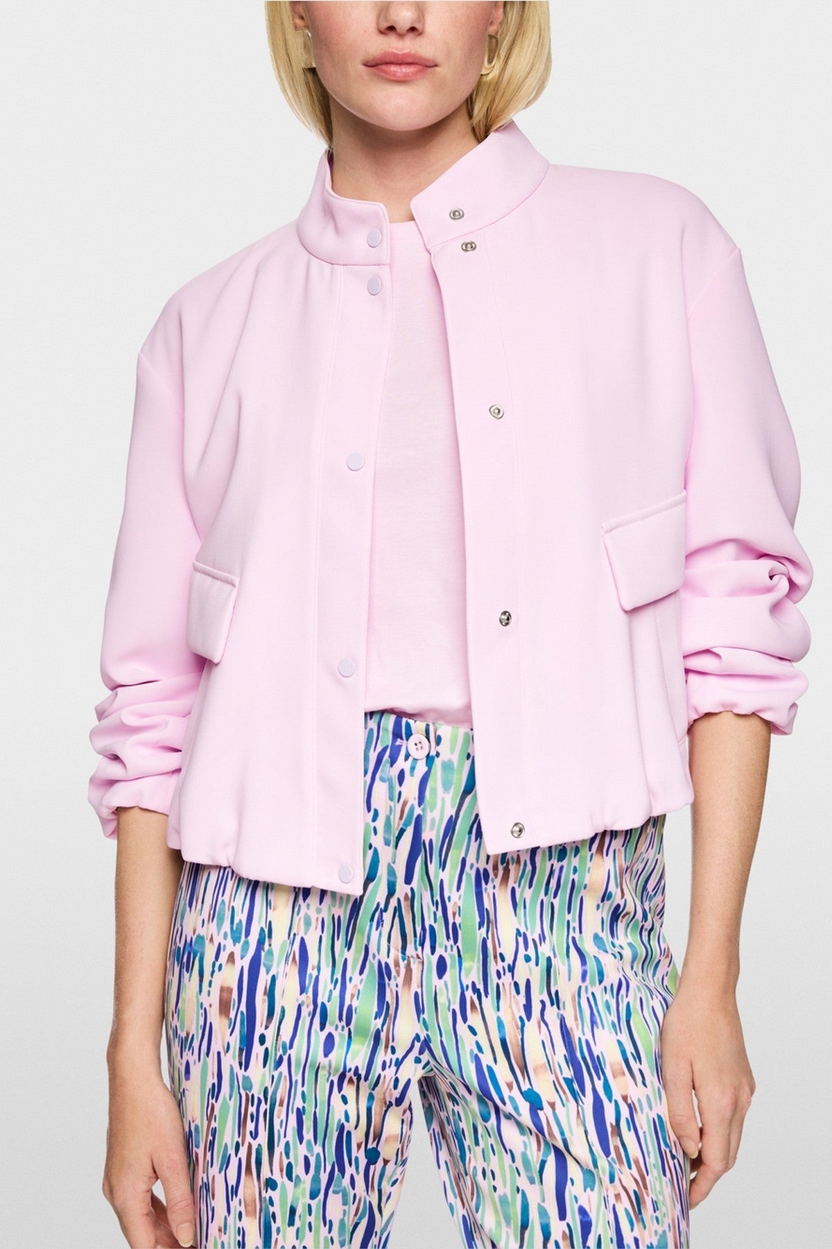 Close-up van de drukknoopsluiting en de elastische boord van het Marc Cain jasje AC 31.08 W56.